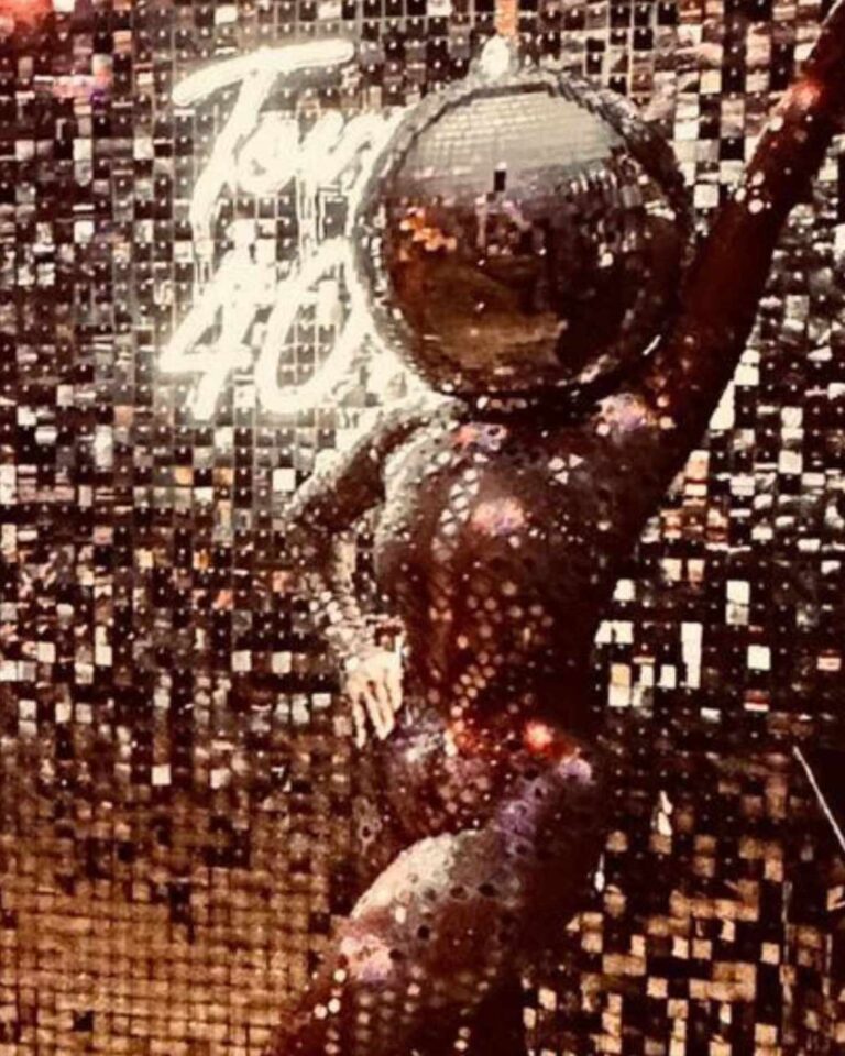 Disco Ball Head entertainer posing in front of silver shimmer wall backdrop